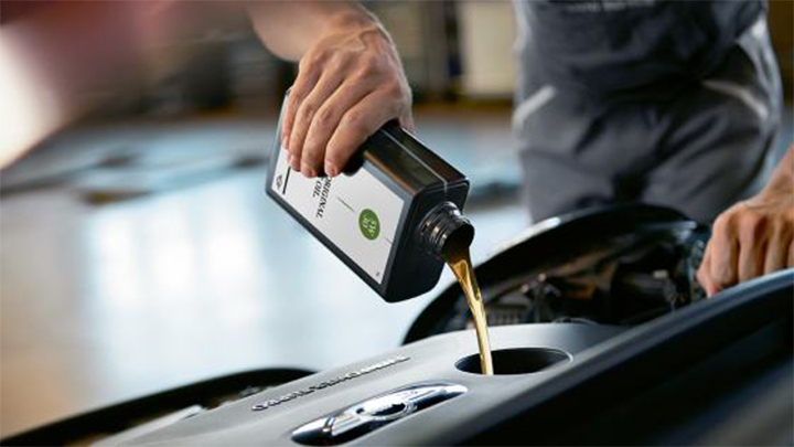 mini technician topping up oil