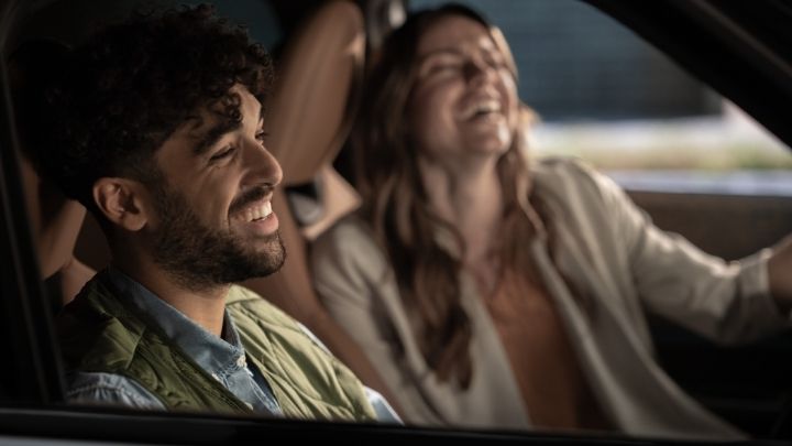 Man and woman laughing in a MINI