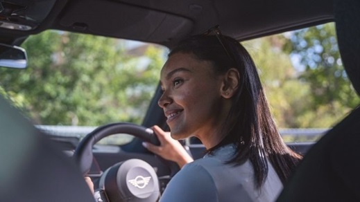 Woman driving a MINI with a smile on her face