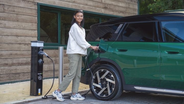 Woman charging her green MINI