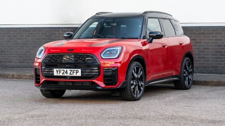 Red MINI parked in front of a brick wall