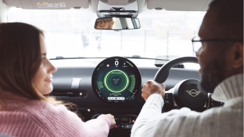 Two people in a Mini black interior