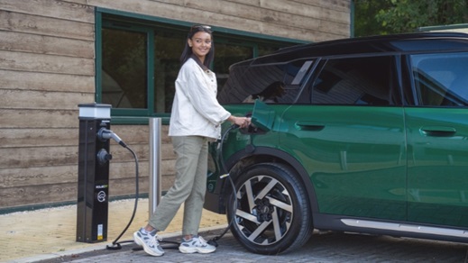 Green Mini Countryman being plugged in to charge
