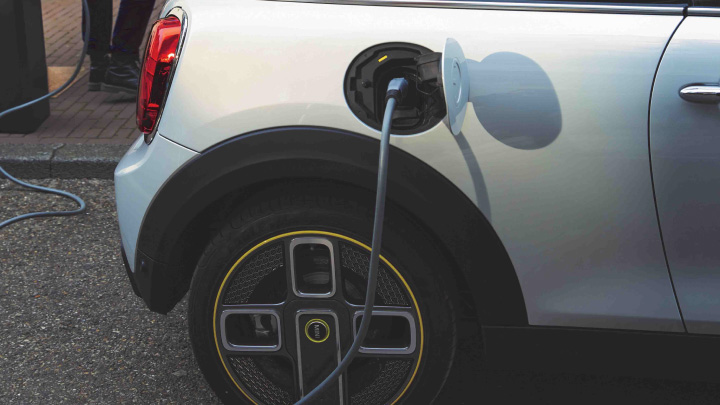 Charging cable plugged into white MINI