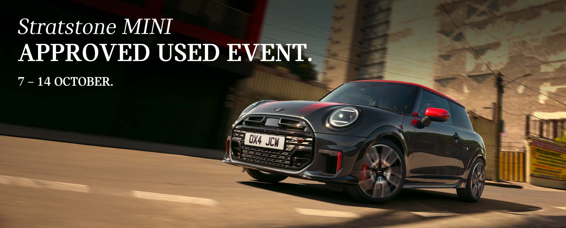 Black And Red MINI Driving On Road Low Angle