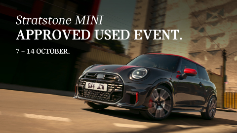 Black And Red MINI Driving On Road Low Angle