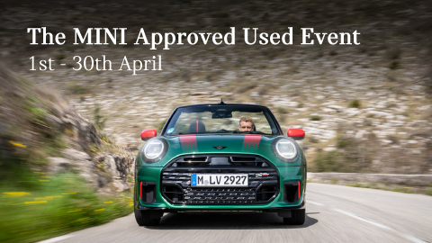 A front shot of a green MINI car with red accents driving with a rockey mountain backdrop. Promotional text overlay.