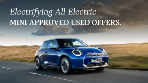 Blue MINI Driving Down Country Road