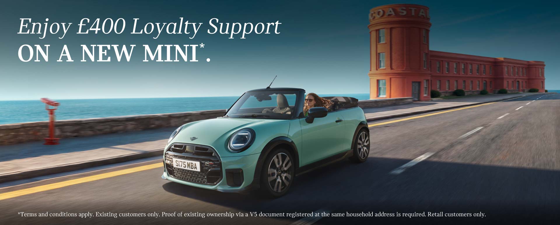 Teal MINI Convertible Driving On Seafront Road
