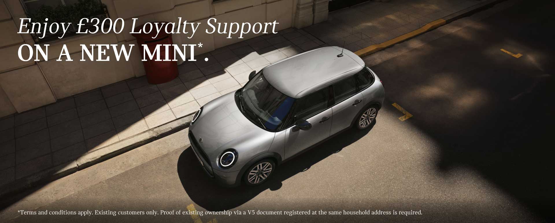 Overhead shot of a parked silver MINI car on a city street. White promotional text overlay.