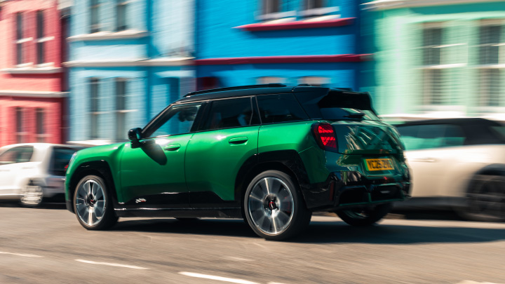 Teal MINI Convertible Driving On Seafront Road