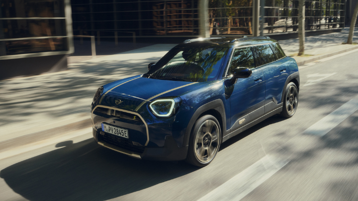 Blue MINI Driving on Road