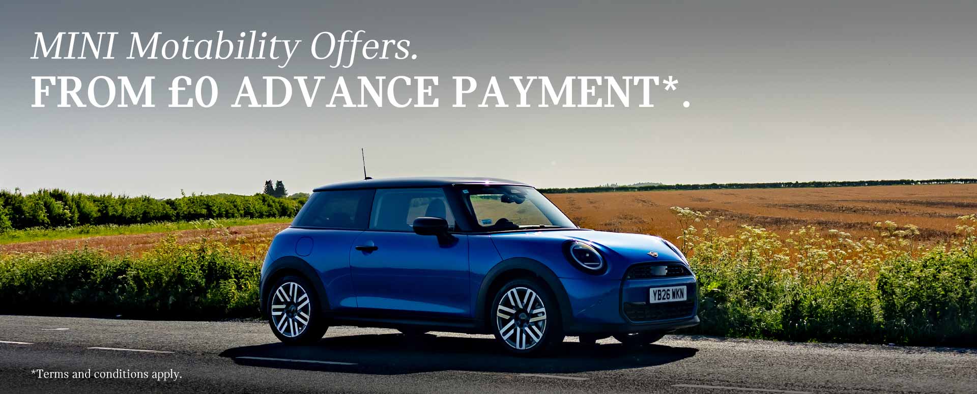 Blue MINI Driving On Road Next To A Field