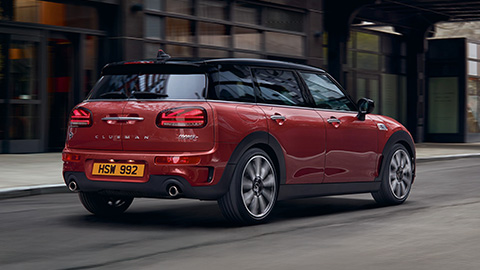 Rear end of a red MINI Clubman driving on the road