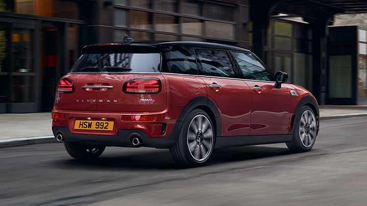 Rear end of a red MINI Clubman driving on the road