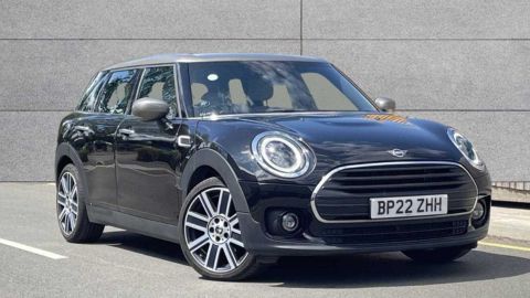Black Mini Clubman Cooper Exclusive parked in front of a grey wall