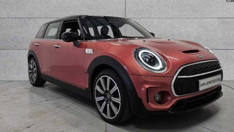 Red Mini Clubman Cooper S Exclusive parked in front of a grey wall