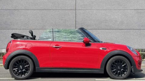 Red MINI Convertible Classic parked in front of a grey wall