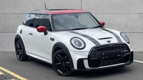 White MINI Cooper Classic parked in front of a grey wall