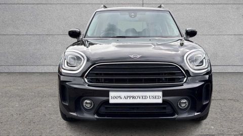 Black MINI Countryman Cooper Exclusive parked in front of a grey wall