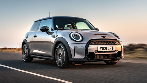 Silver MINI Hatch driving on the road