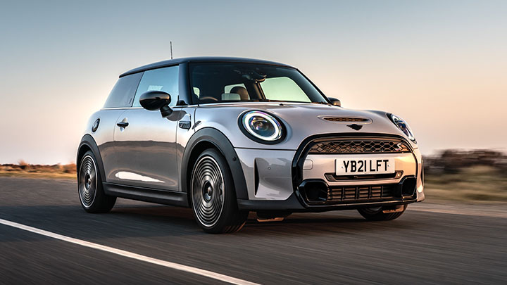Silver MINI Hatch driving on the road