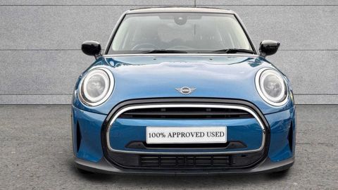Blue MINI Hatch Cooper Classic parked in front of a grey wall
