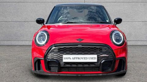 Red MINI Hatch Cooper Sport parked in front of a grey wall