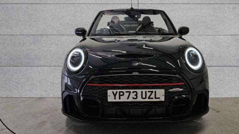 Black MINI Hatch John Cooper Works parked in front of a grey wall