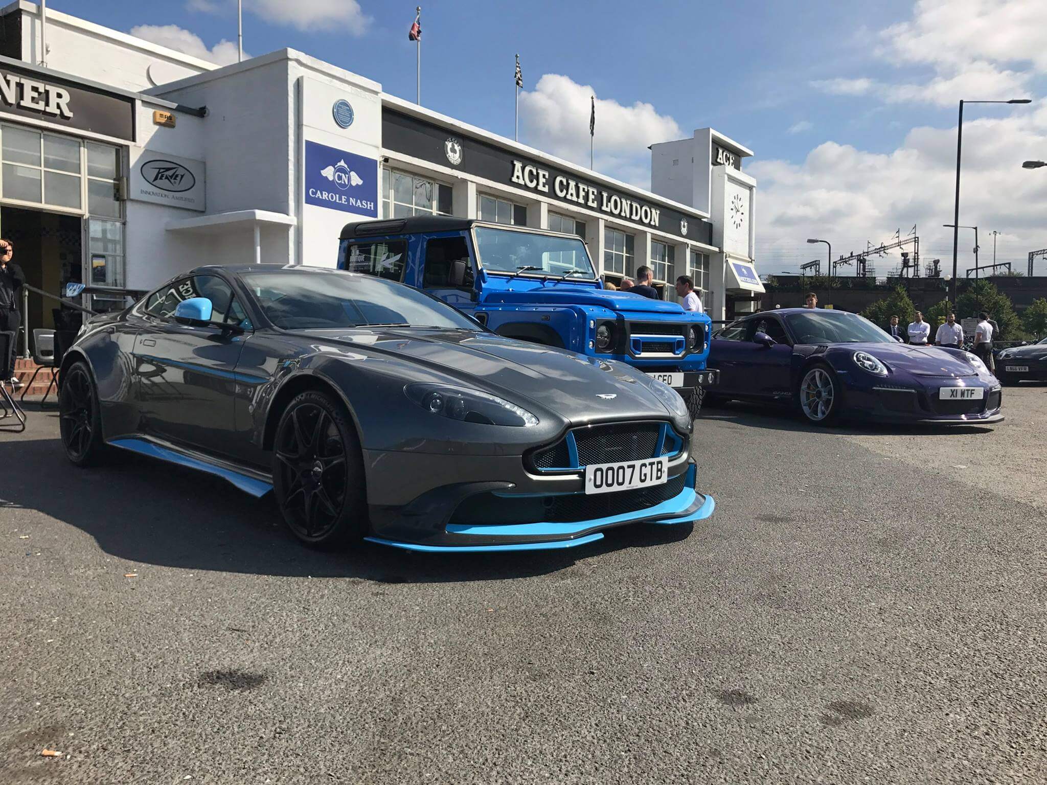 aston martin vantage, land rover defender and porsche 911