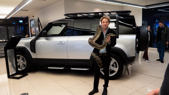 Jack Randall with a python and the New Land Rover Defender