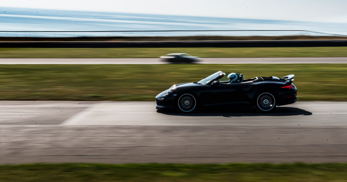 Black Porsche Cabriolet Driving