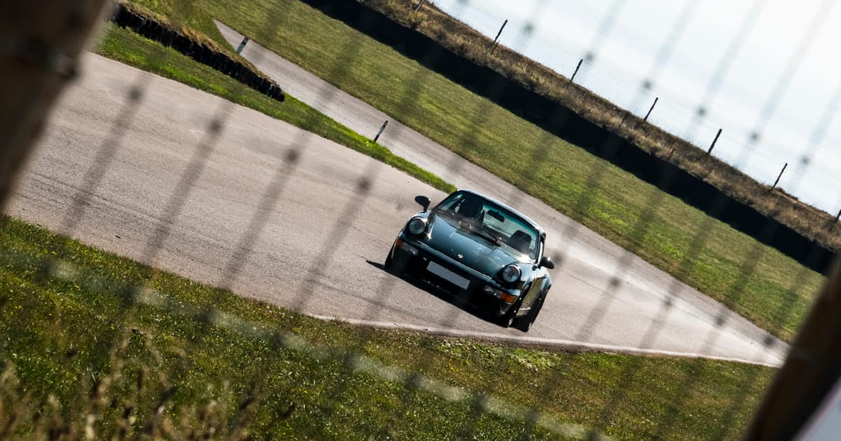 Green Porsche 911 Driving