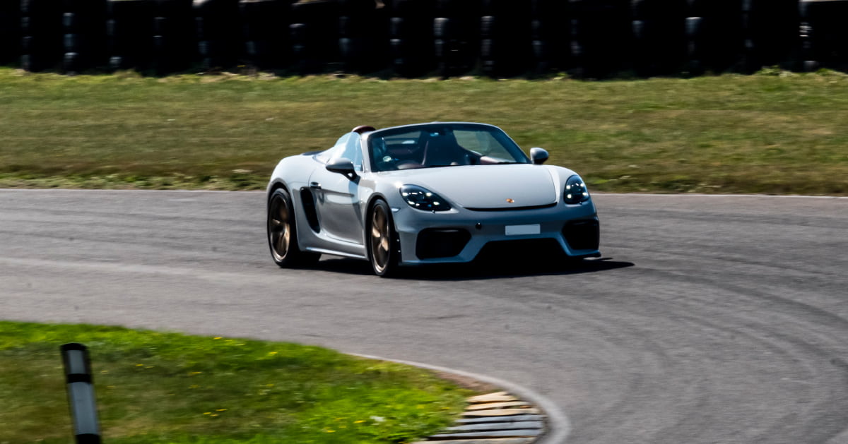 Grey Porsche Cayman Spyder Cornering