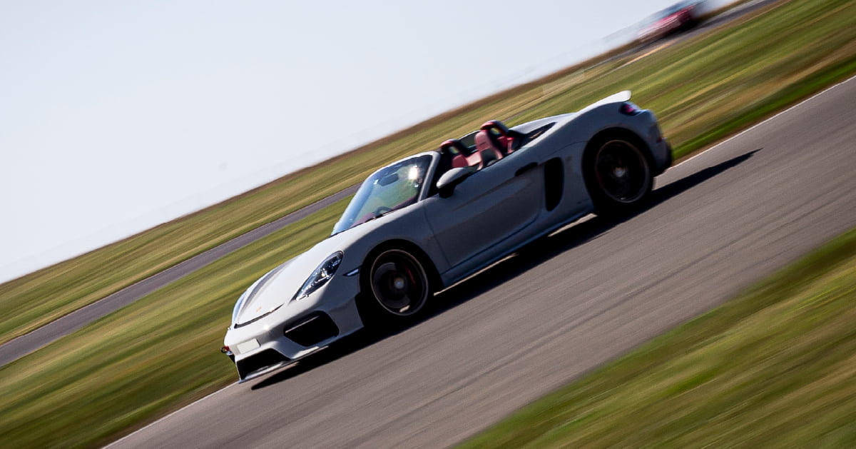 Silver Porsche Cayman Spyder Driving