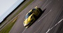 Yellow Porsche Cayman GT4 Driving