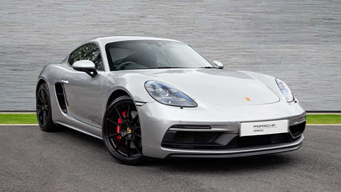 Grey Porsche 718 Cayman GTS parked in front of a grey background