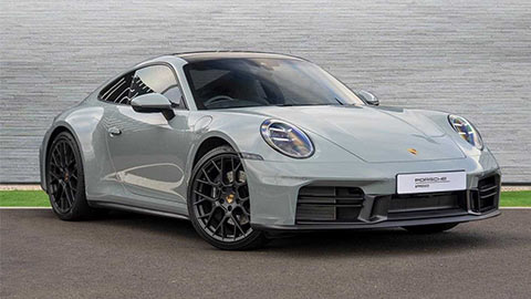 Grey Porsche 911 Carrera parked in front of a grey background