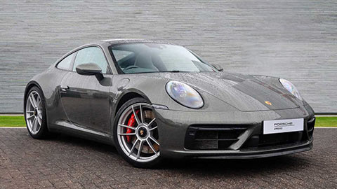 Grey Porsche 911 GTS parked in front of a grey background