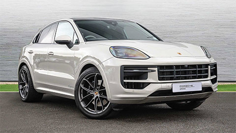 Light grey Porsche Cayenne e Hybrid parked in front of a grey background