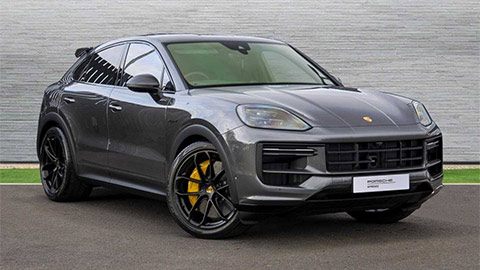 Dark Grey Porsche Cayenne Turbo e-Hybrid parked in front of a grey background