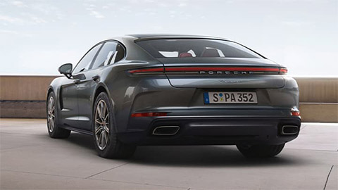 Grey Porsche Panamera parked in front of a wall