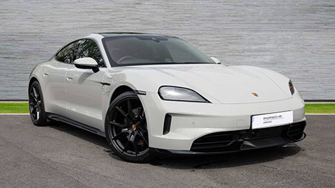 Grey Porsche Taycan parked in front of a grey background