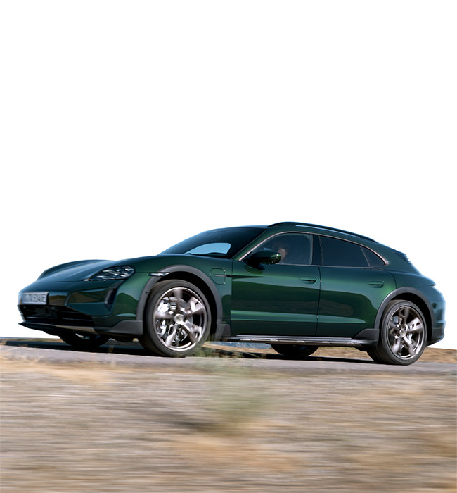 Green Porsche Taycan Cross Turismo driving with a white background