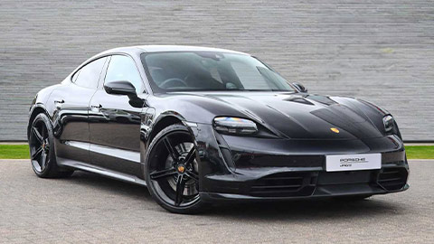 Grey Porsche Taycan Turbo parked in front of a grey background
