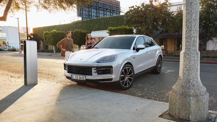White Porsche Cayenne Parked at Road Side with People in Conversation