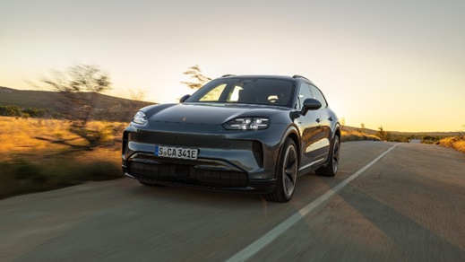 Porsche Cayenne Electric driving front angle at sunset