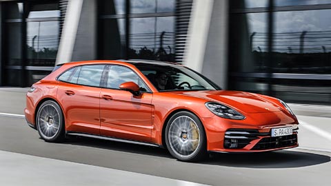 Orange Porsche Panamera Driving