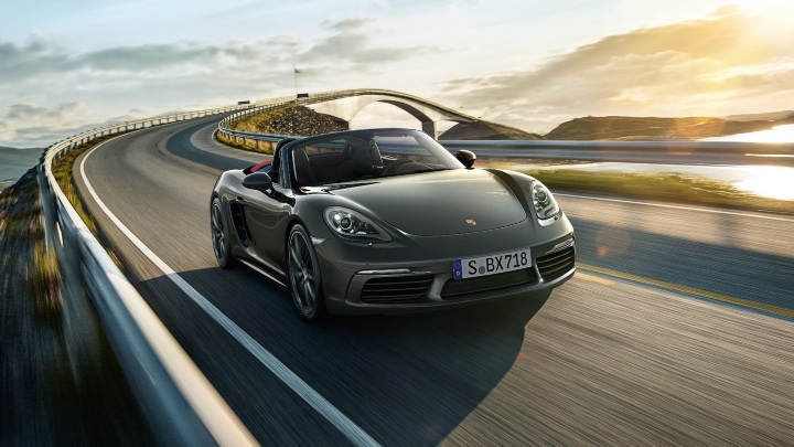 Porsche 718 driving on road