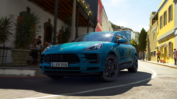 New blue Porsche Macan on the road.
